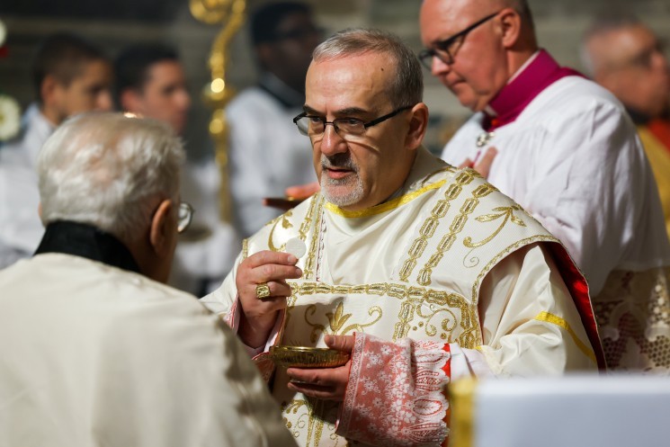 Cardinal Pierbattista Pizzaballa, patriarch of Jerusalem, distributes Communion.