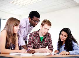 Four high school students studying together. iStock photo.