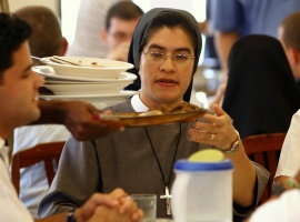 Sister M. Seraphica Montez, a U.S. nun with the Sisters of St. Francis of the Martyr St. George, eats lunch with Cuban seminarians at San Carlos and San Ambrosio Seminary outside Havana Feb. 9. She teaches English, works in the library and tends to plant s on the grounds of the seminary. (CNS photo/Nancy Phelan Wiechec)