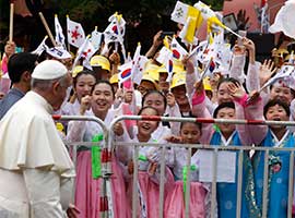 Young people in traditional dress cheer as Pope Francis arrives for a meeting with representatives of religious communities working in South Korea during an encounter in Kkottongnae, South Korea, in August 2014. CNS photo/Paul Haring