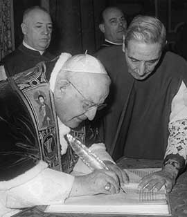 Pope John XXIII signs the bull convoking the Second Vatican Council Dec. 25, 1961. CNS photo.