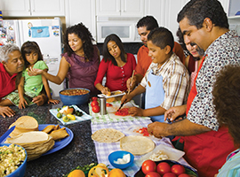 A Latino family prepares a meal together. Blend Images photo for illustrative purposes only.