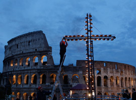 worker-lights-torches-on-cross-ahead-of-2012-way-of-the-cross-in-rome-cns-paul-haring-montage-0009.jpg