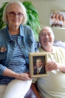 Beverly and Tom Burnett, Sr. hold a photograph of their son Tom, Jr. who died during the September 11, 2001 attacks. Tom, Jr. has three daughters who are pictured behind Beverly and Tom, Sr., From left, Madison and Halley, 15 and Anna Clare 13. Photo: Jim Bovin for the Catholic Spirit. 