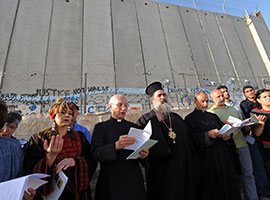 Christian leaders pray in front of the Israeli separation wall in Bethlehem, West Bank, in 2010. CNS photo/Debbie Hill