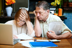 Couple are distressed while paying bills. 