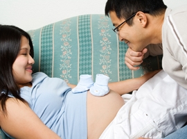 A happy expectant couple prepares for the birth of their child. iStock image used for illustrative purposes only.