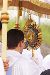 A monstrance holding the Eucharist is displayed in a procession.