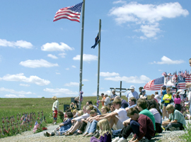 Tourists gather on a hillside at the temporary memorial site in Shanksville, Pa., where United Flight 93 crashed on 9/11/01. CNS photo/Ed Zelachoski, Catholic Accent.