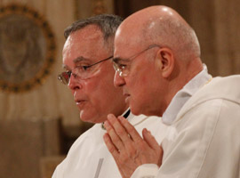 Philadelphia Archbishop Charles J. Chaput, OFM Cap and Archbishop Carlo Maria Vigano, apostolic nuncio to the United States, pray during the Fortnight for Freedom Closing Mass. (CNS Photo/Bob Roller)