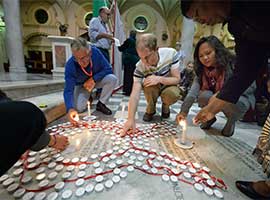Participants of the the 2016 International AIDS Conference light candles at at the Roman Catholic Emmanuel Cathedral in Durban, South Africa, in July 2016. CNS photo/Paul Jeffrey