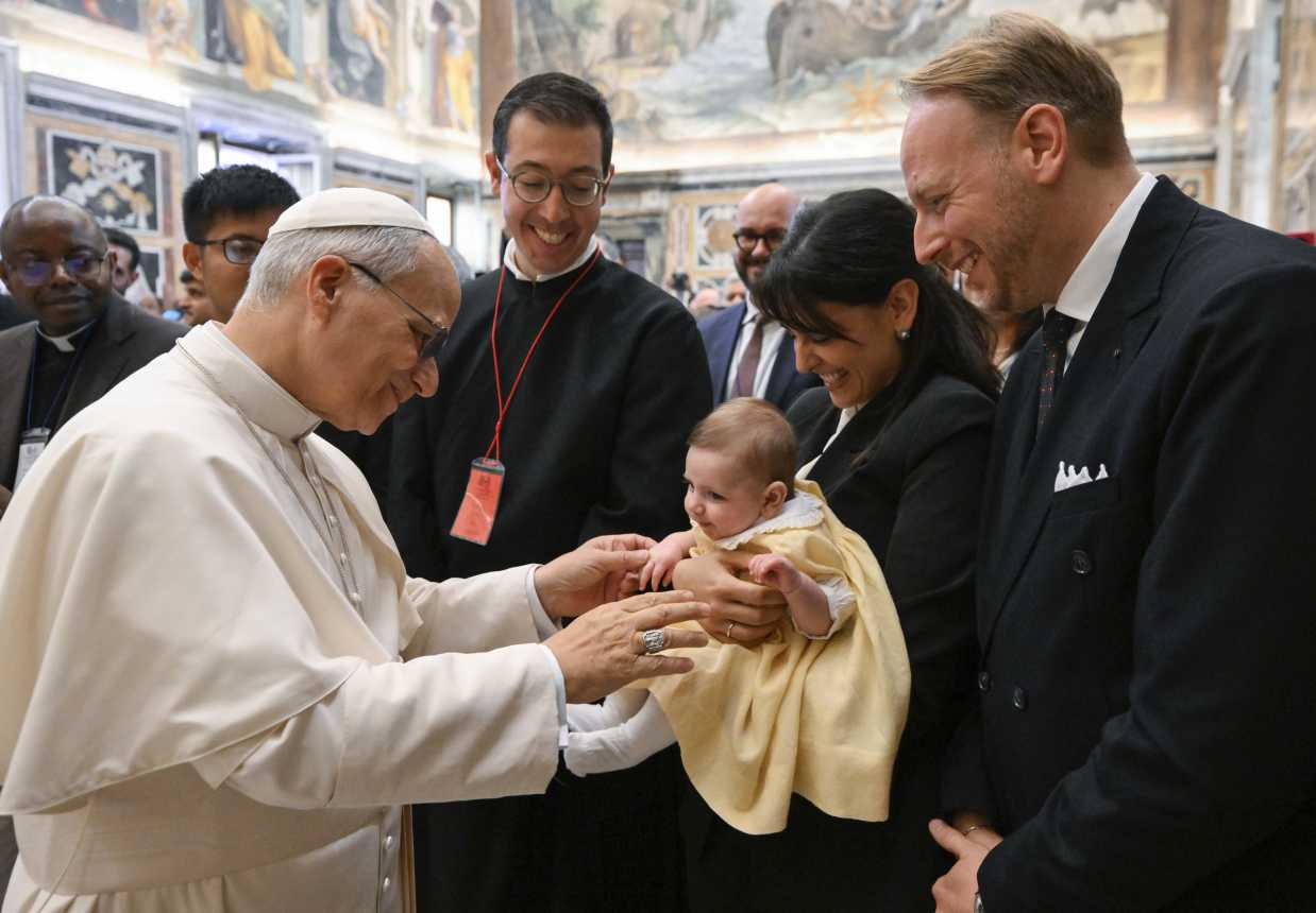Pope Leo greets a baby and parents