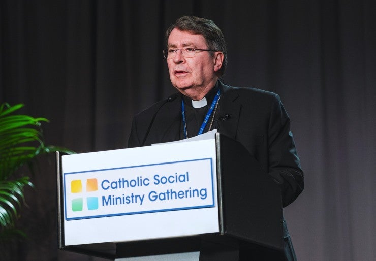 Cardinal Pierre speaks from podium