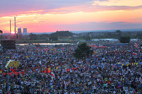 The sun sets over World Youth Day pilgrims as Pope Francis attends a July 30 prayer vigil at the Field of Mercy in Krakow, Poland. (CNS photo/Bob Roller)
