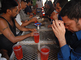 Migrants pray before breakfast at a dining facility in Nogales, Mexico, that is supported by the Jesuit-run Kino Border Initiative. CNS photo/David Maung