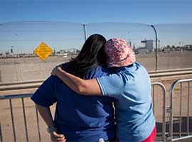 Women embrace as they watch the Mass with Pope Francis from the U.S. side of the border in El Paso, Texas, in February 2016. CNS Photo/Nancy Wiechec