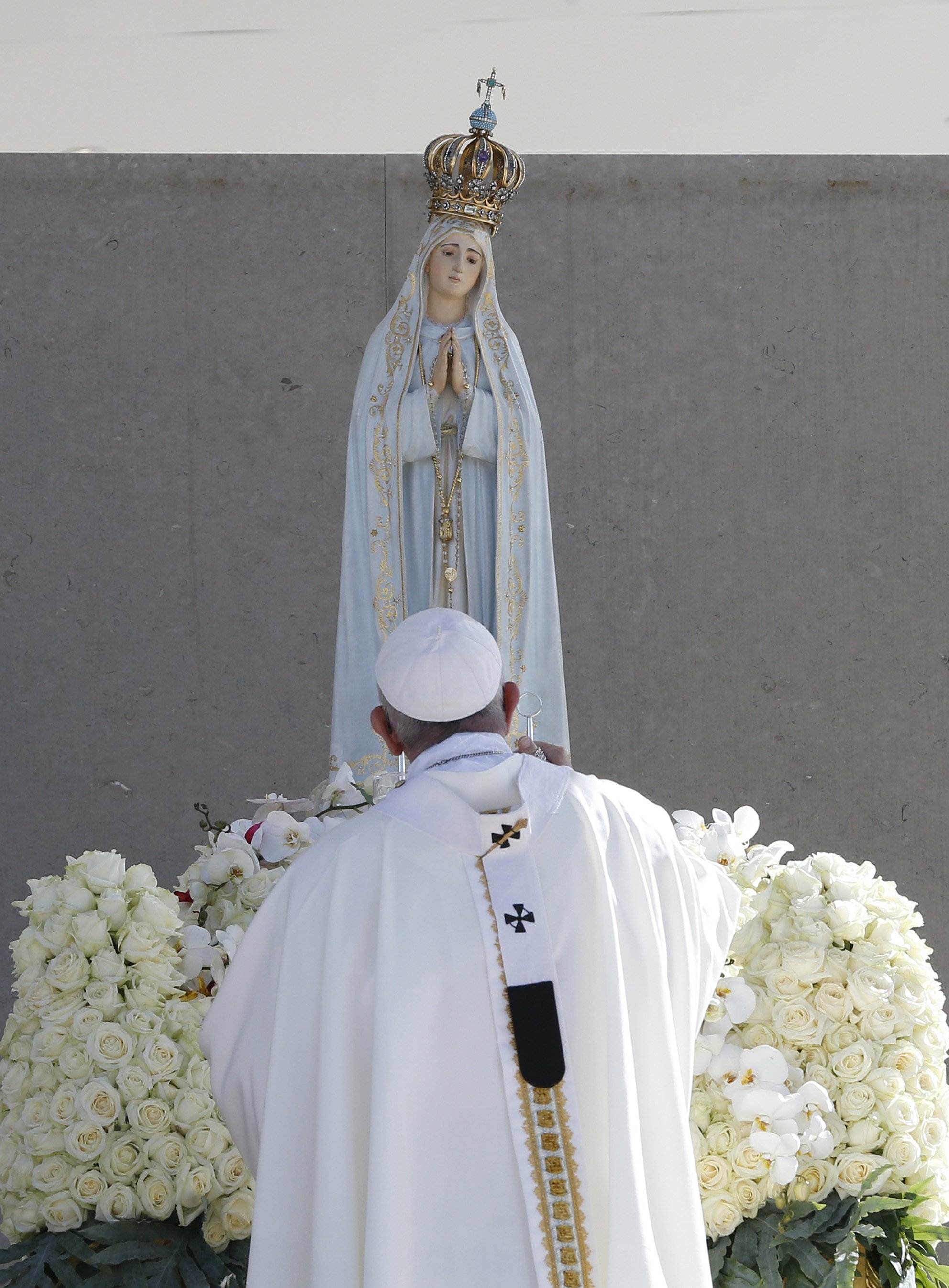 Pope Francis uses incense to venerate a statue of Our Lady of Fatima.