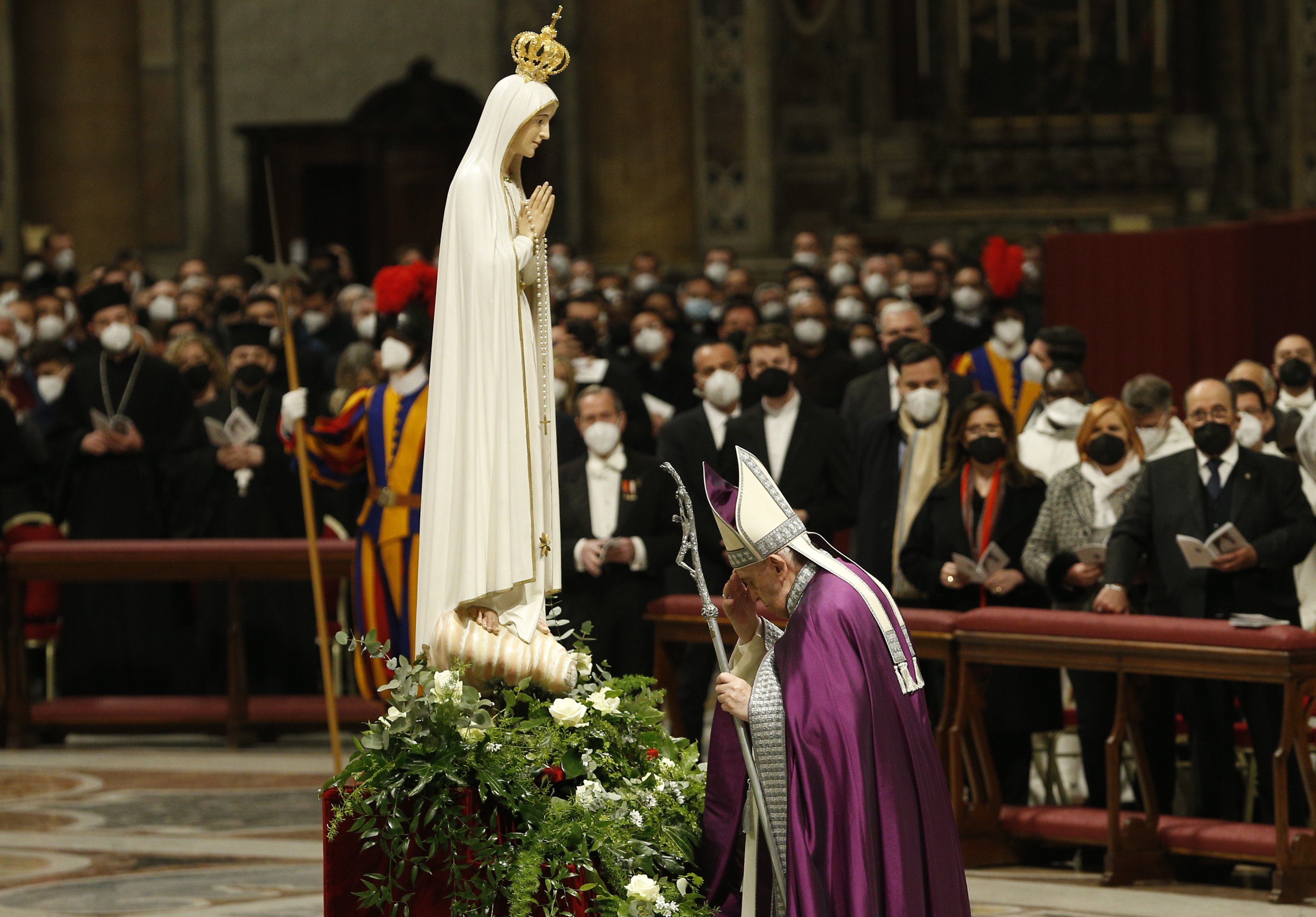 Pope Francis prays before a statue of Our Lady of Fátima
