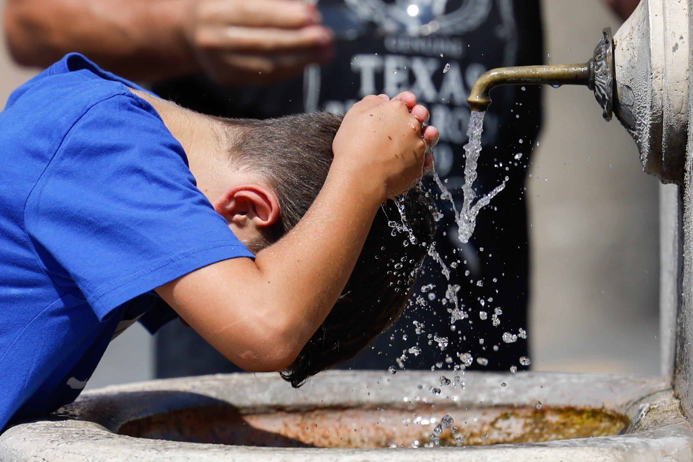 Boy cools off in fountain