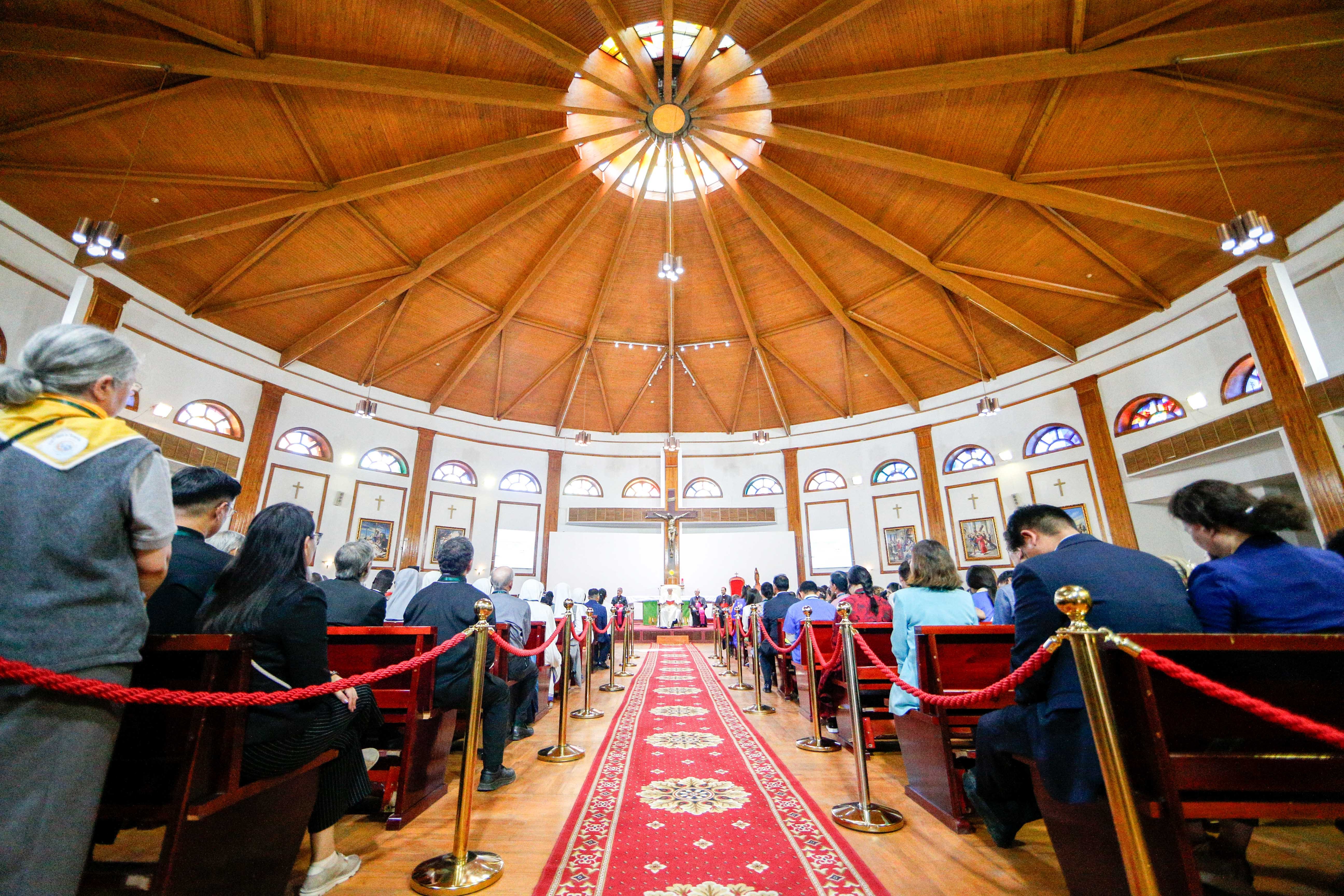 Pope Francis meets with Mongolian Catholics in a cathedral. 