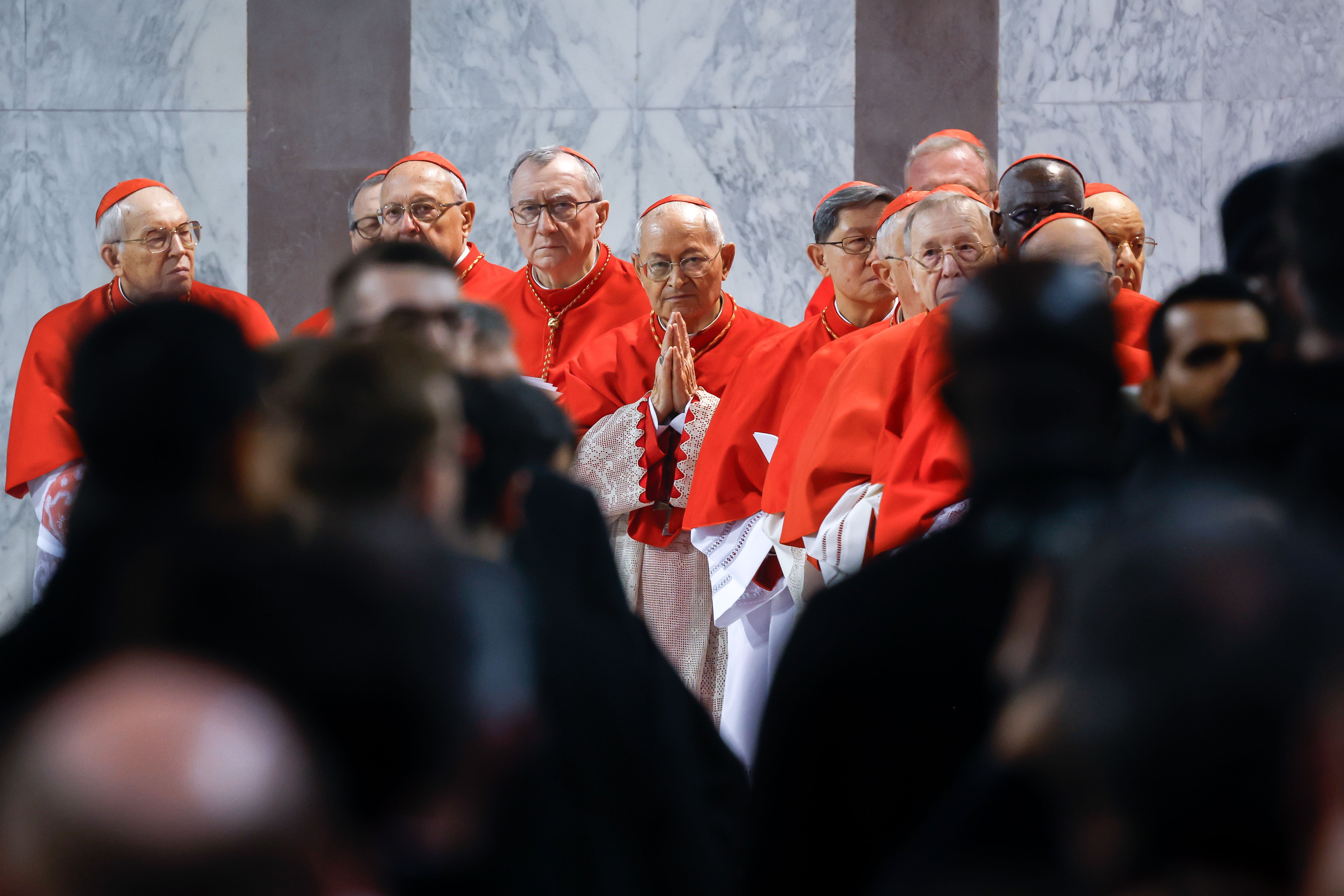 Cardinals pray.