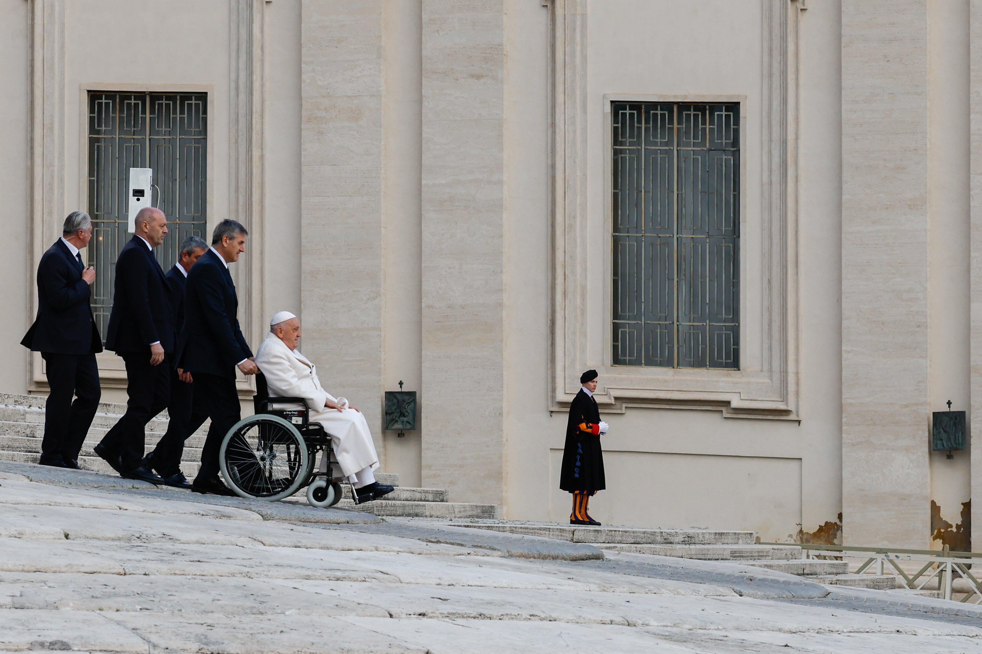 Pope Francis uses a wheelchair to leave St. Peter's Square.