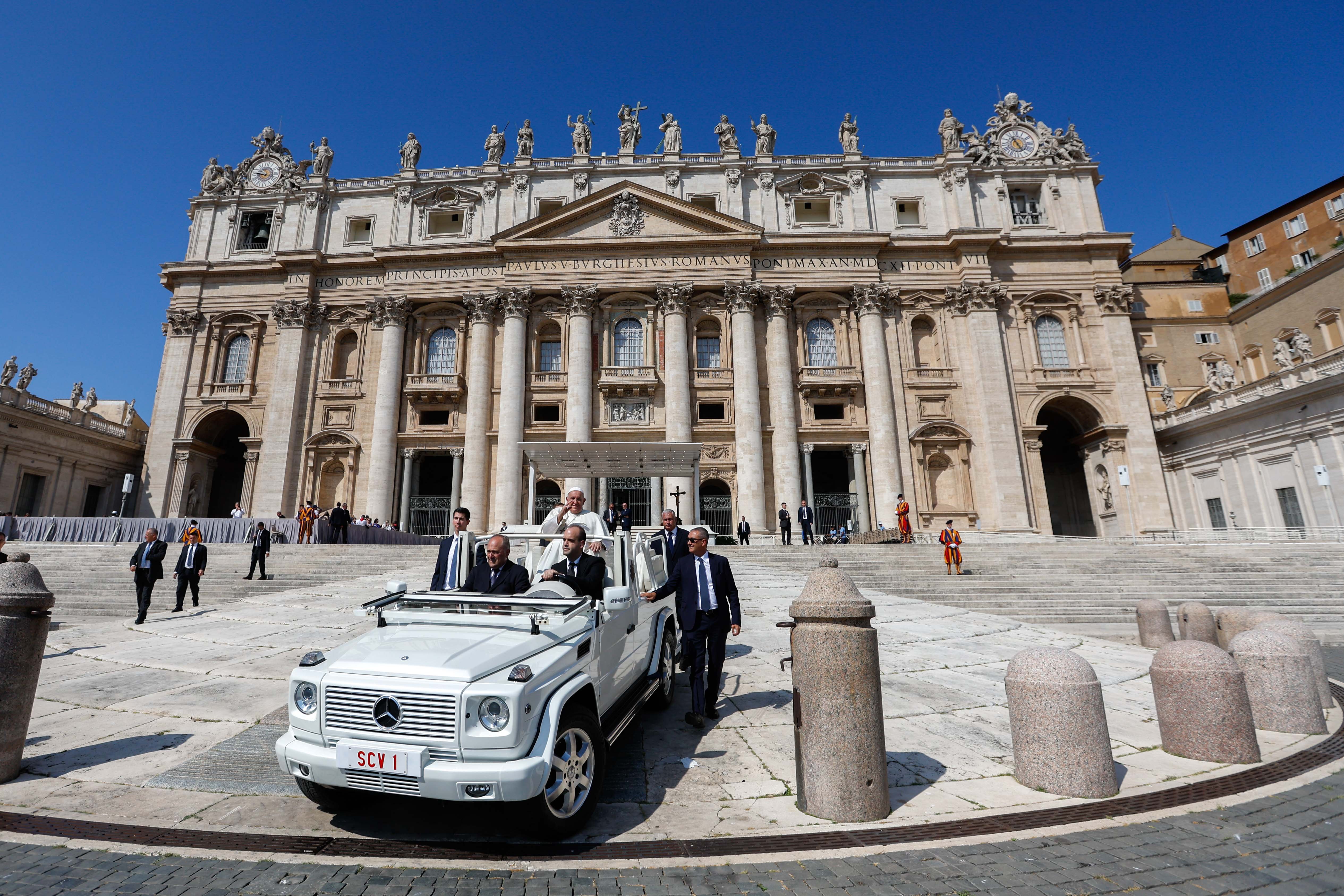 Pope Francis rides the popemobile.