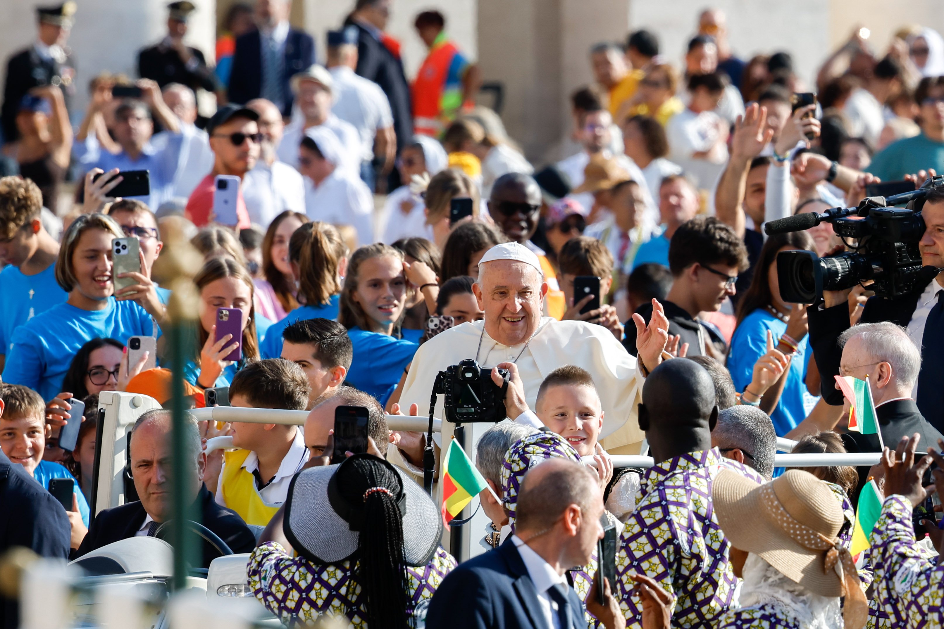 Pope Francis waves to visitors from the popemobile.