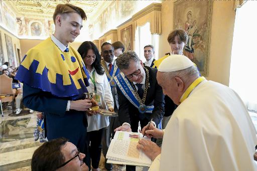 Pope Francis signs a book