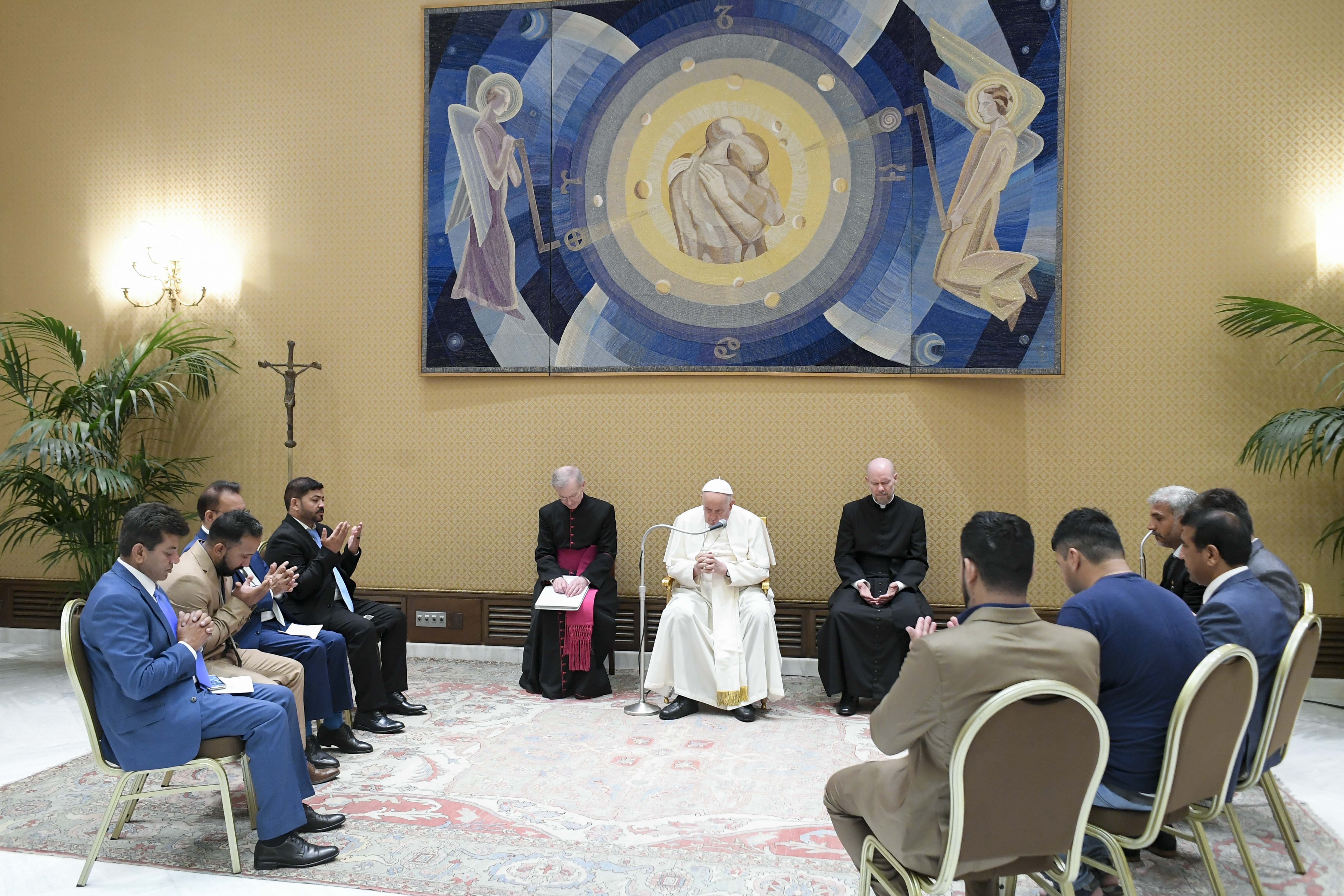 Pope Francis prays with Afghan community members