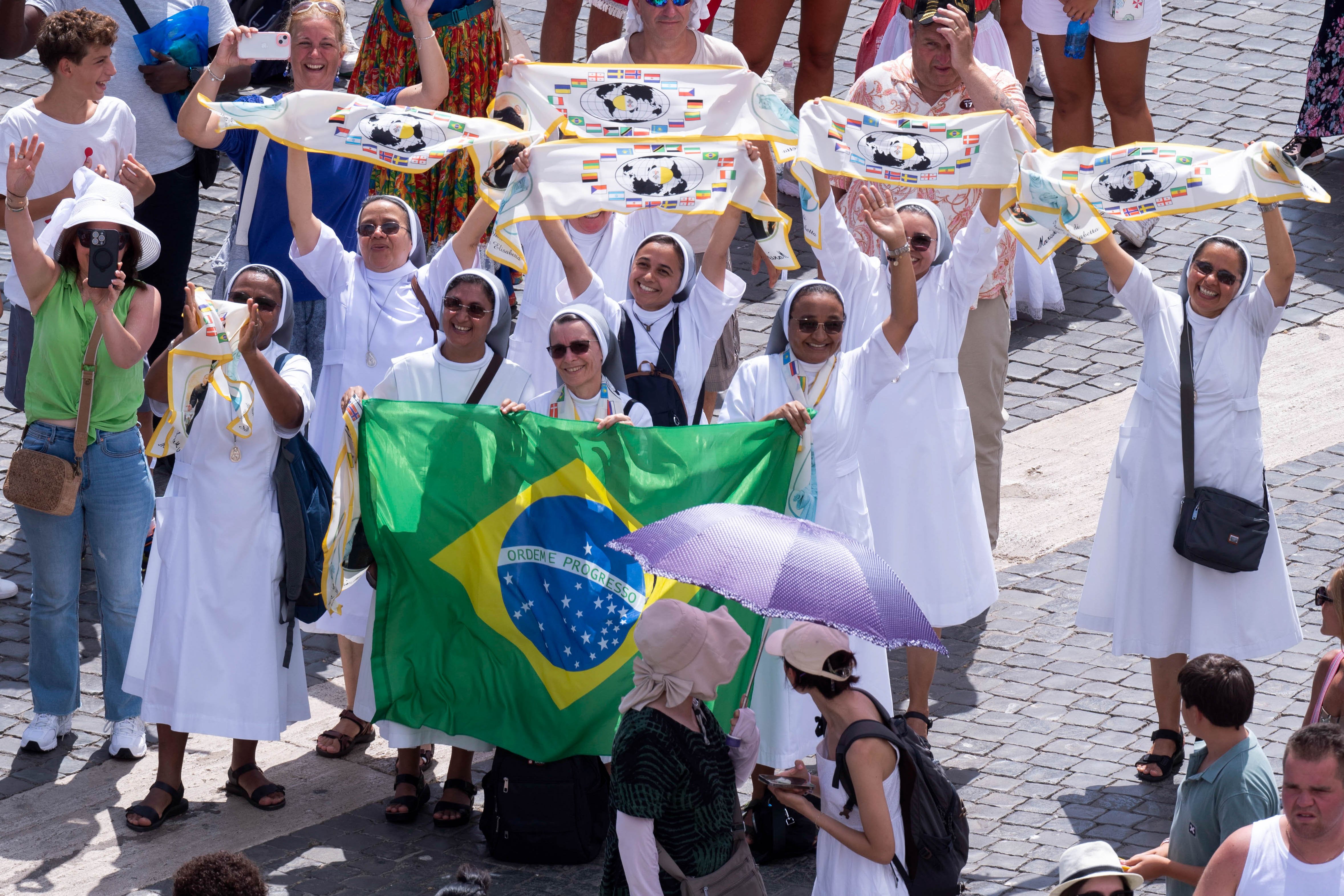 Women religious hold Brazilian flag