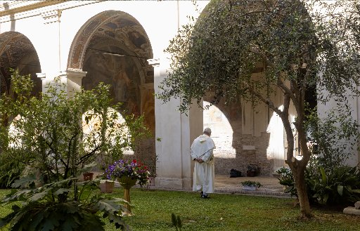 A Dominican friar walks in the garden