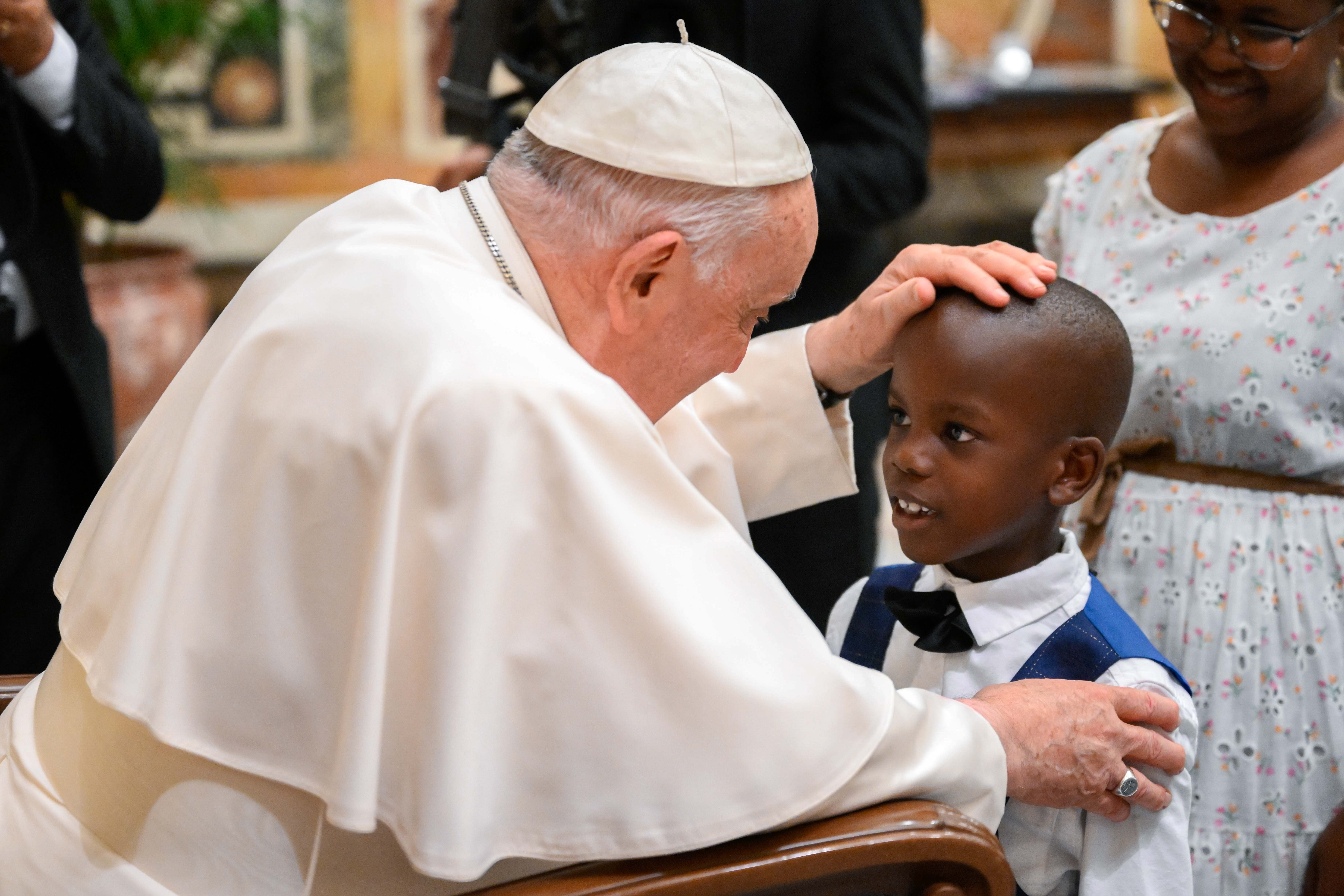 Pope Francis greets a child at meeting with Catholic legislators