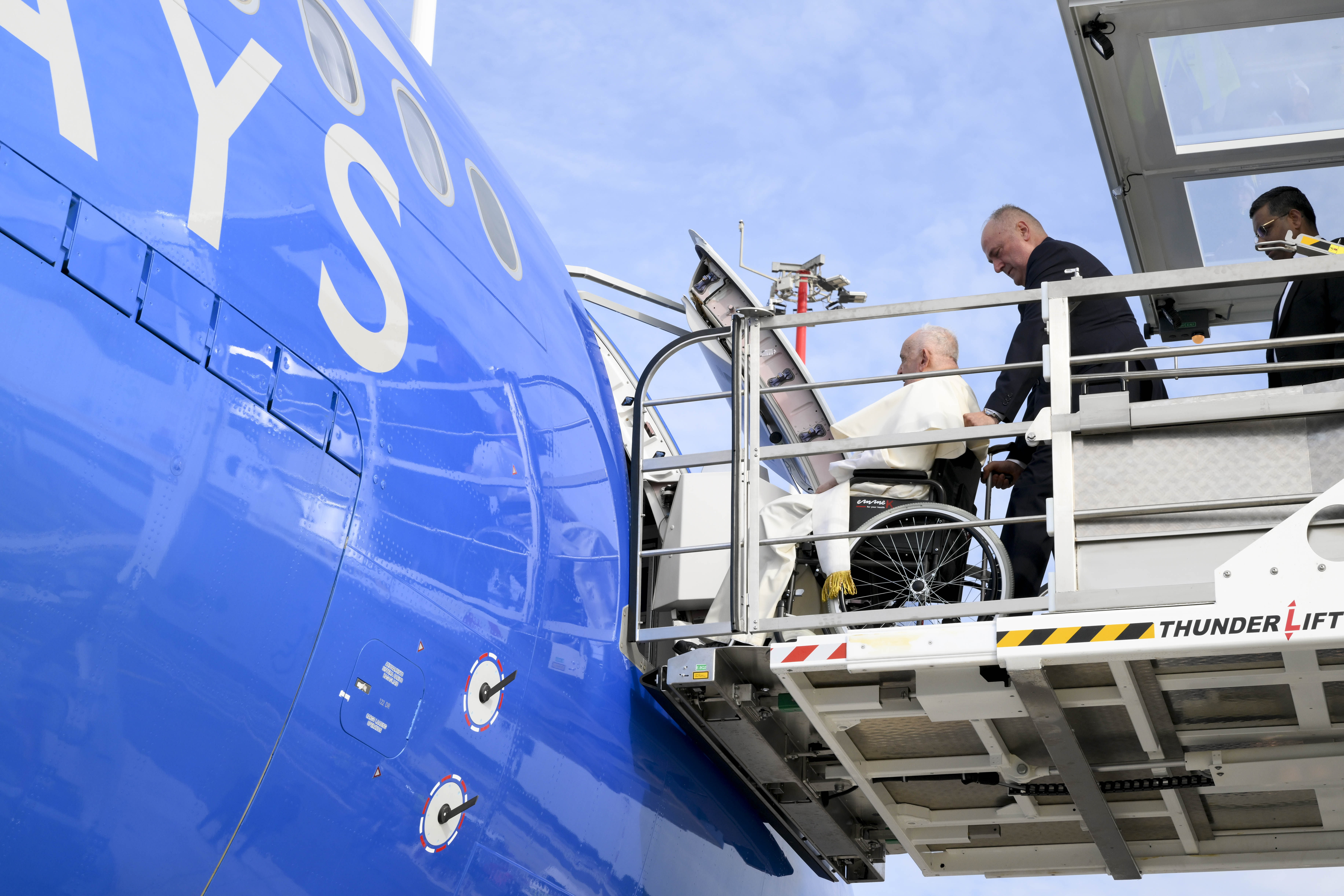 Pope Francis boards a plane.