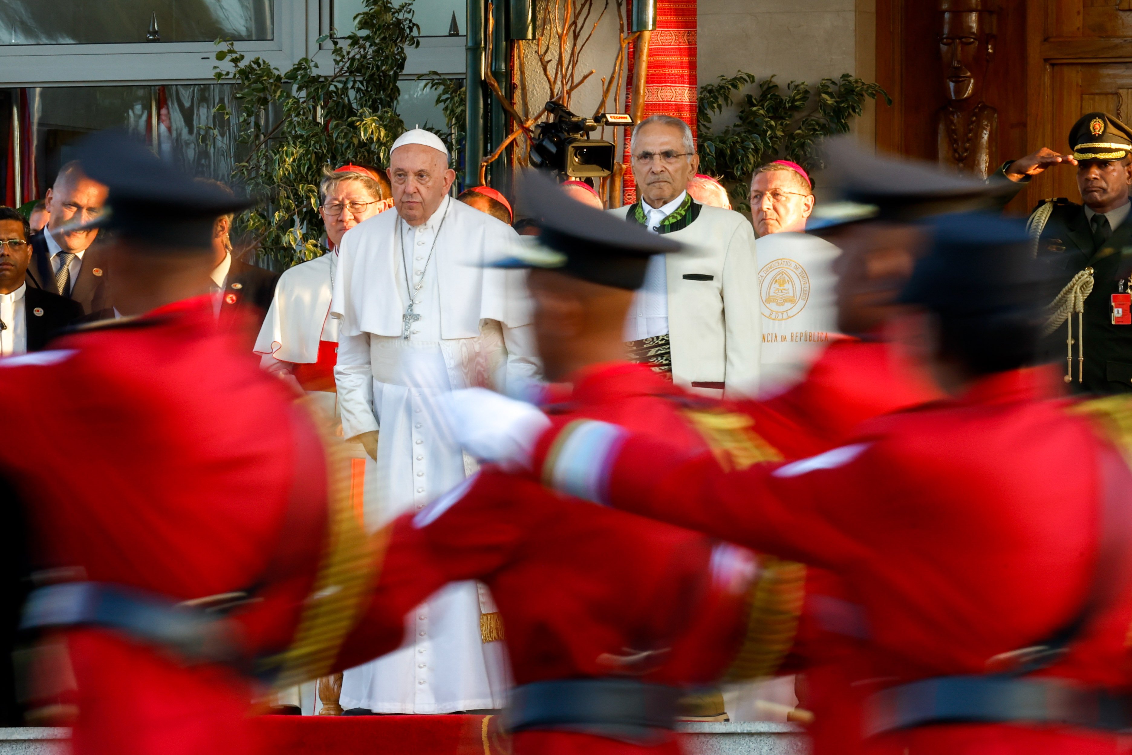 An honor guard marches past Pope Francis and the president of Timor-Leste.