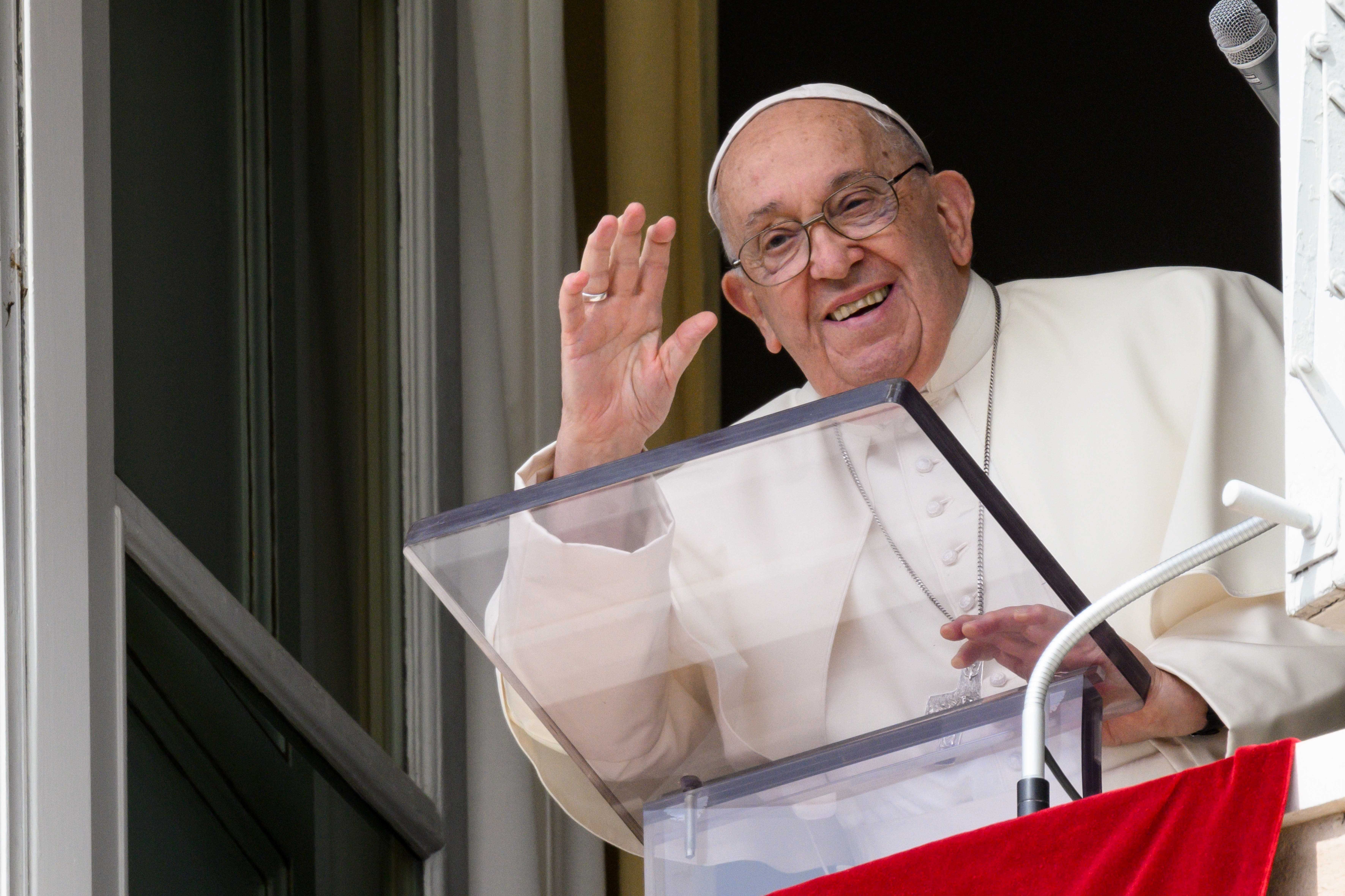 Pope Francis waves to visitors in St. Peter's Square