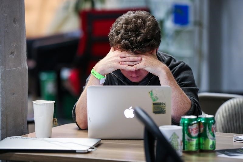 A young man works at a computer.