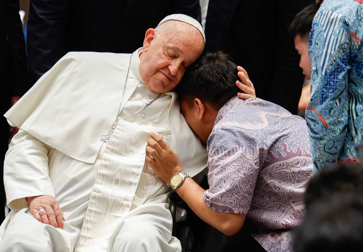 Pope Francis comforts a person in Indonesia