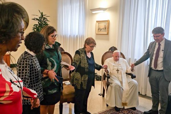 Pope Francis prays with community organizers