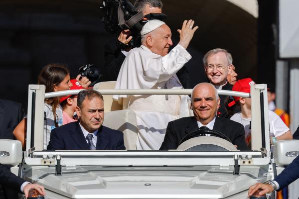 Pope Francis waves to visitors from the popemobile.