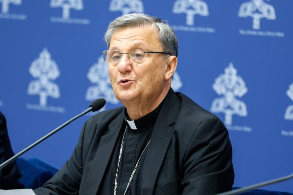 Cardinal Mario Grech speaks at a news conference.