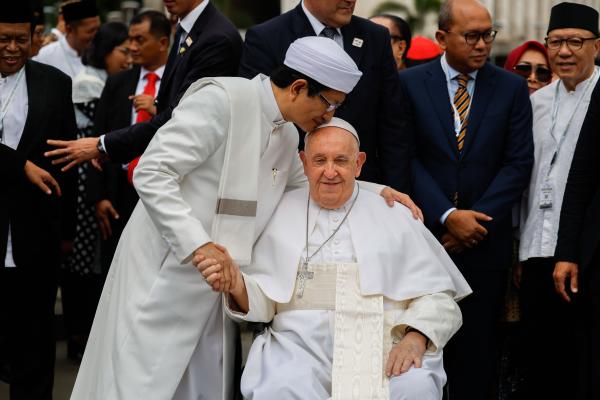 Pope Francis receives a kiss from an imam.