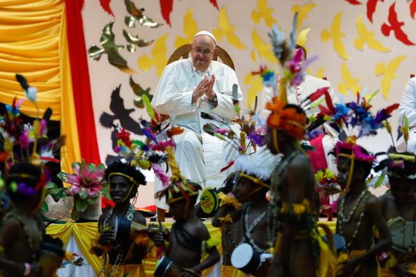 Pope Francis applauds.