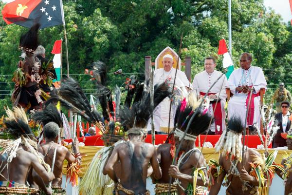 Pope Francis observes as traditional dancers perform. 