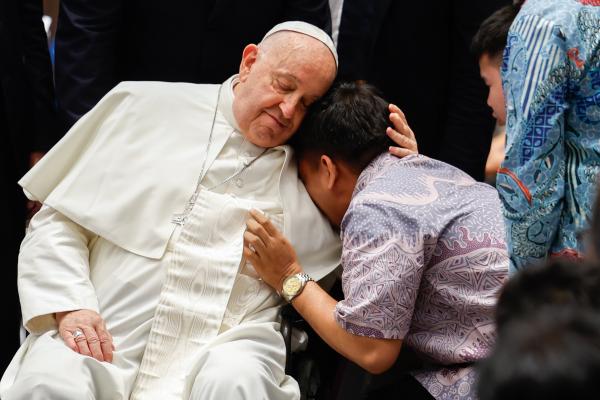 Pope Francis comforts a person in Indonesia