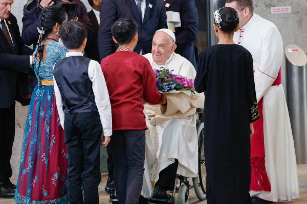 Pope Francis greets children upon arriving in Singapore.