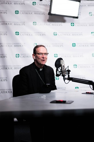 Bishop Michael Burbidge talking into microphone on a zoom call