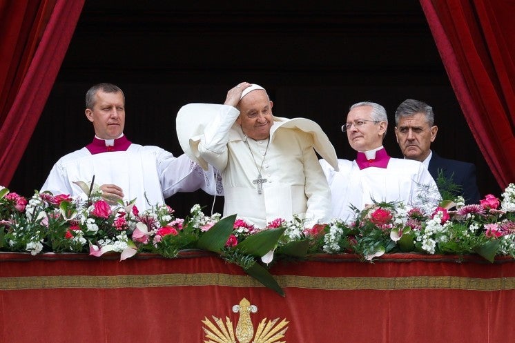 Pope Francis holds his zuccehtto.